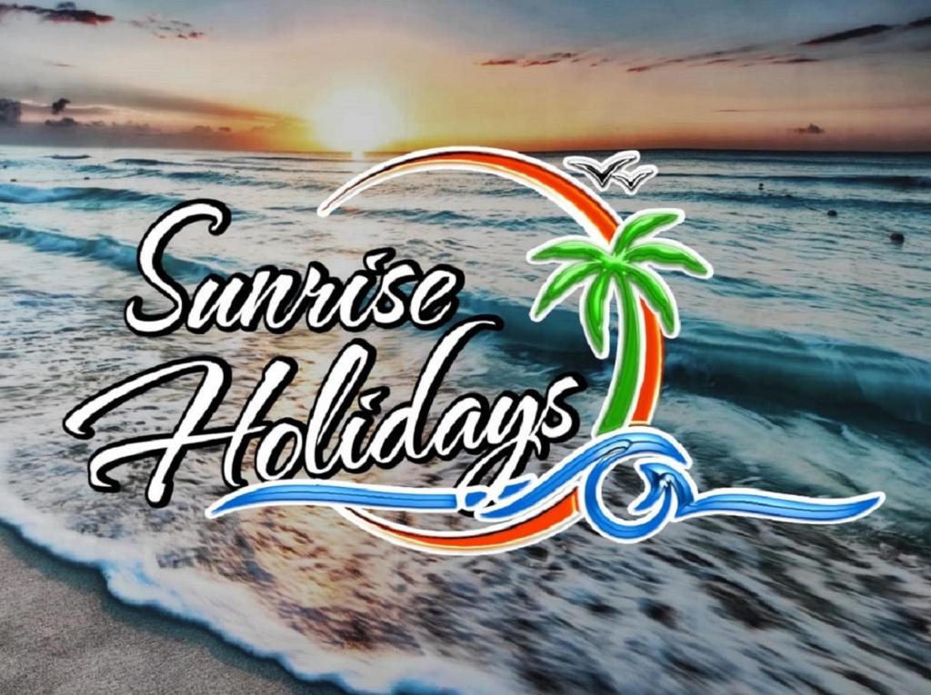 a picture of a beach with a palm tree and the words sunrise holidays at Sunrise Holidays in Porto Santo
