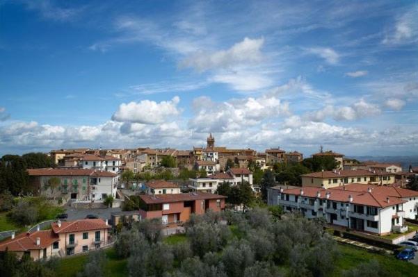 a group of houses in a town under a cloudy sky at Casa Borghellina in Montaione
