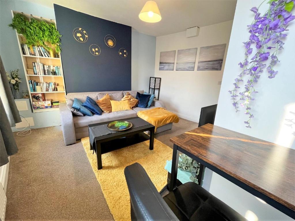 a living room with a couch and a table at Winchester Retreat in Winchester