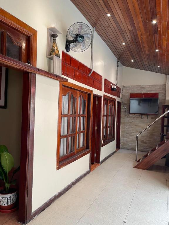 a hallway of a building with a fan on the wall at Casa de Lujo 5 estrellas ! in Iquitos