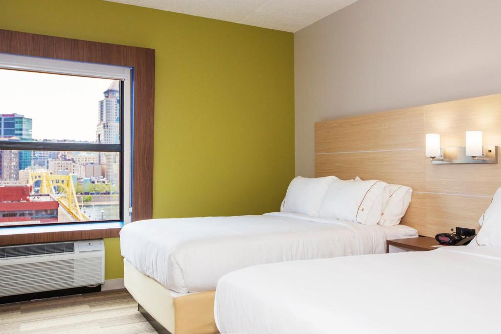 a hotel room with two beds and a window at Holiday Inn Express & Suites Pittsburgh North Shore by IHG in Pittsburgh