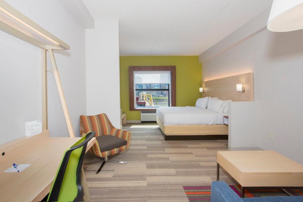 a hotel room with a bed and a desk at Holiday Inn Express & Suites Pittsburgh North Shore by IHG in Pittsburgh