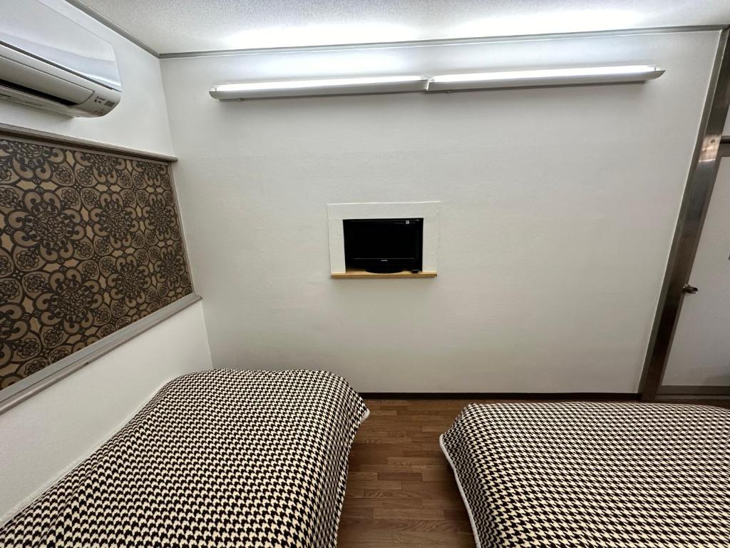 Postel nebo postele na pokoji v ubytování Hotel Rakusai