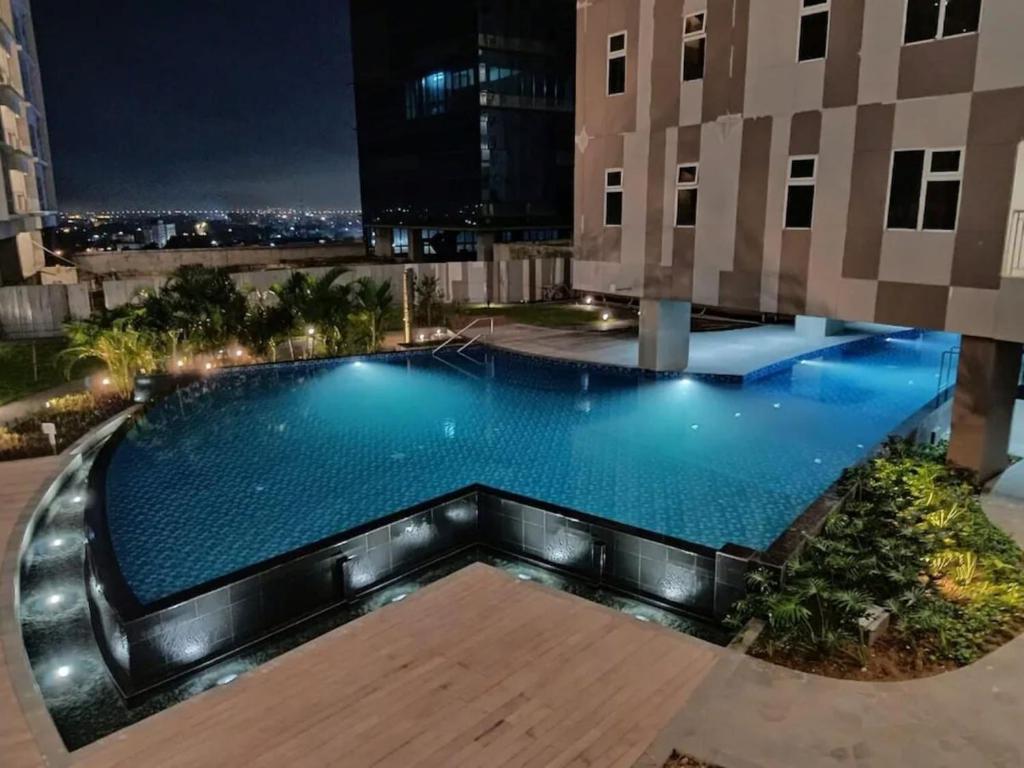 una piscina in cima a un edificio di notte di Fully Furnished 2BR exclusive pool view apartment in Medan a Medan