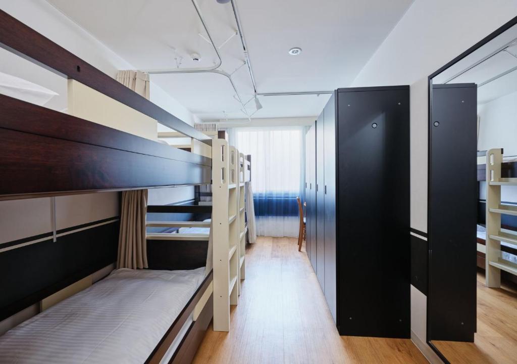 Postel nebo postele na pokoji v ubytování Hotel Graphy Nezu