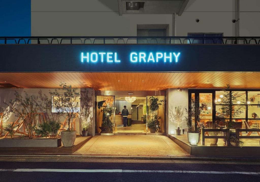 a hotel grarity building with a sign that reads hotel crappy at Hotel Graphy Nezu in Tokyo