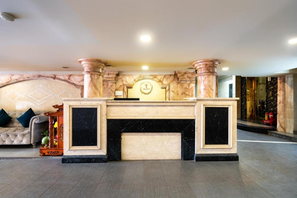 a living room with a fireplace in a building at MINH THƯ HOTEL in Ho Chi Minh City