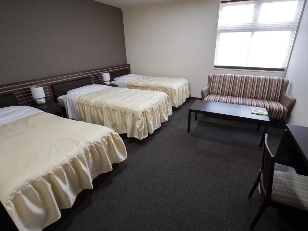 Postel nebo postele na pokoji v ubytování Misato Town Community Lodge Wakuasu