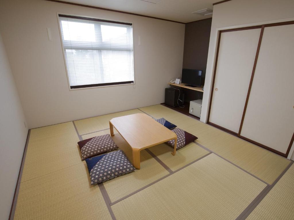 Postel nebo postele na pokoji v ubytování Misato Town Community Lodge Wakuasu