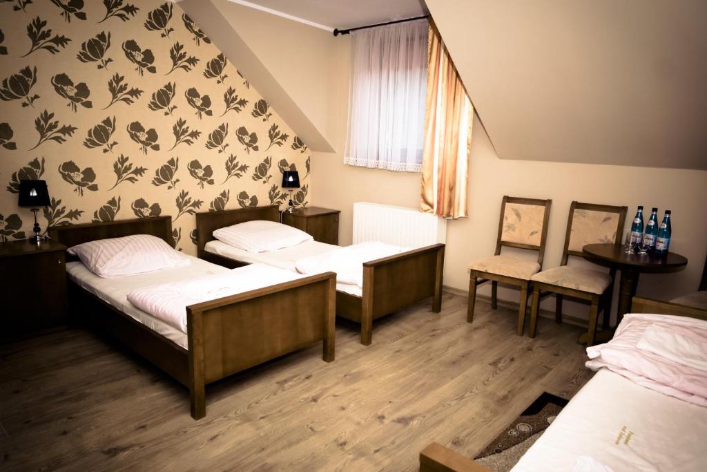 Postel nebo postele na pokoji v ubytování Pensjonat nad Zalewem