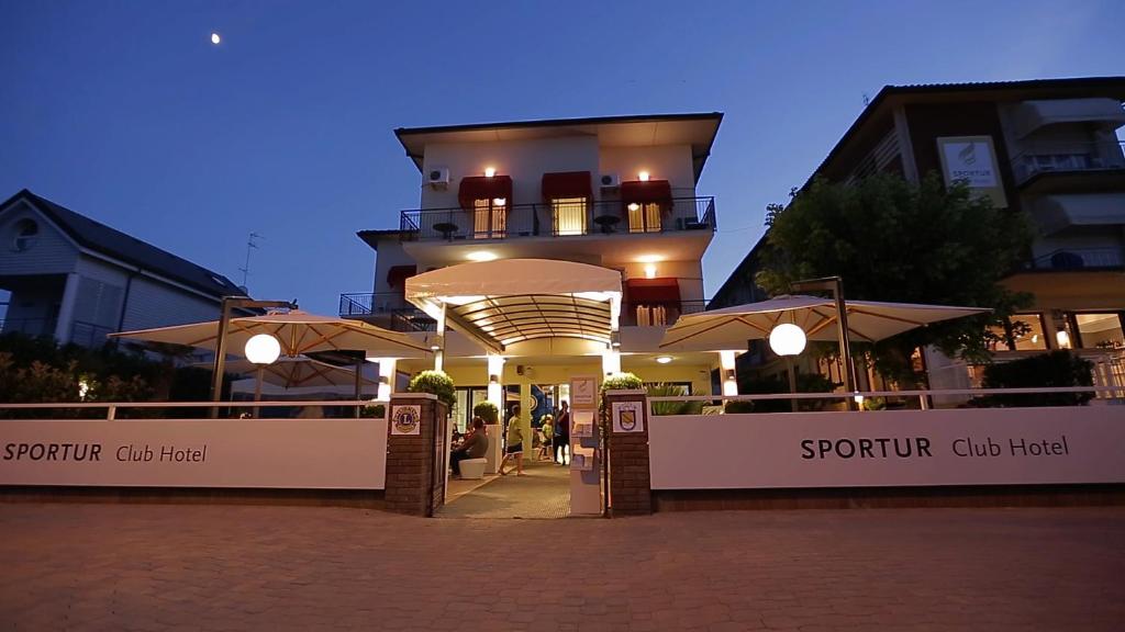 a building with umbrellas in front of it at Sportur Club Hotel in Cervia