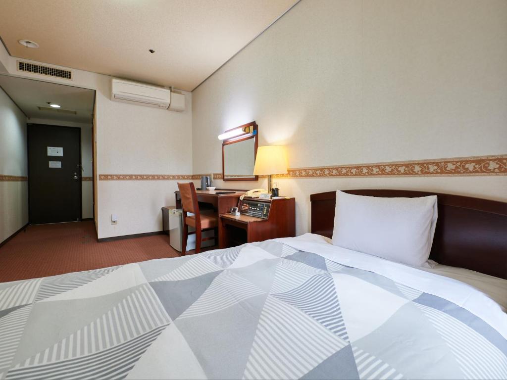 Postel nebo postele na pokoji v ubytování ecoHotel