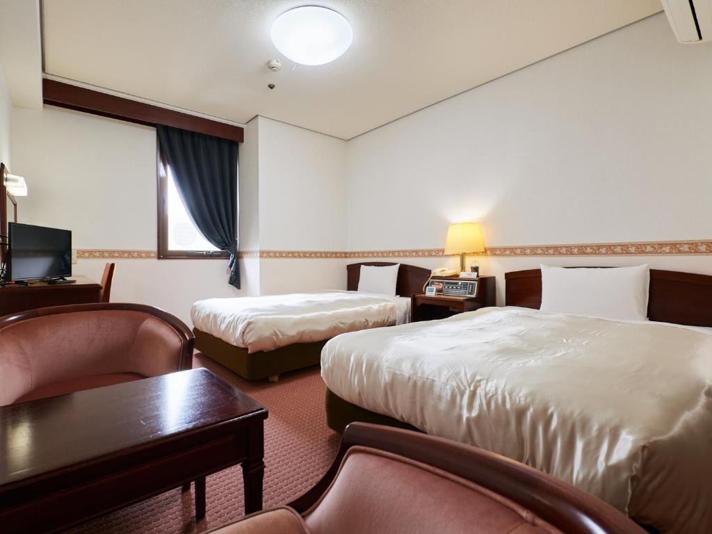 Postel nebo postele na pokoji v ubytování ecoHotel