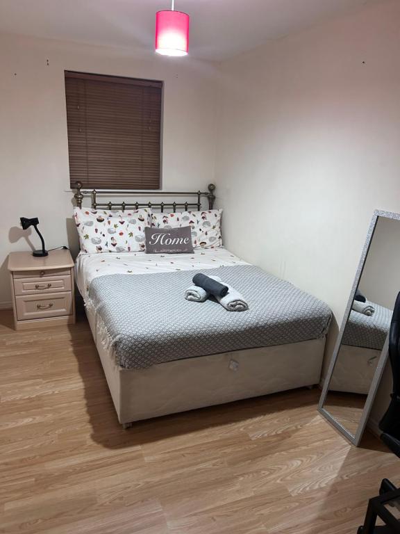 a bedroom with a bed and a mirror in it at Kazo in Purfleet