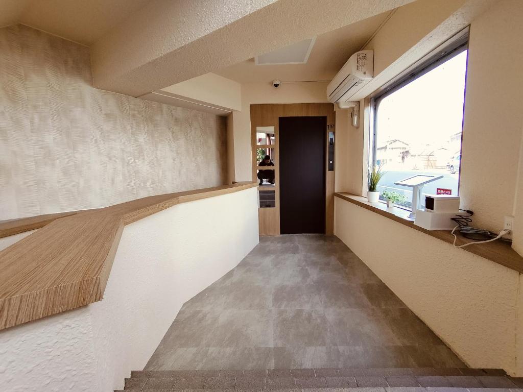 Voodi või voodid majutusasutuse FLYCAT INN 伊勢 toas