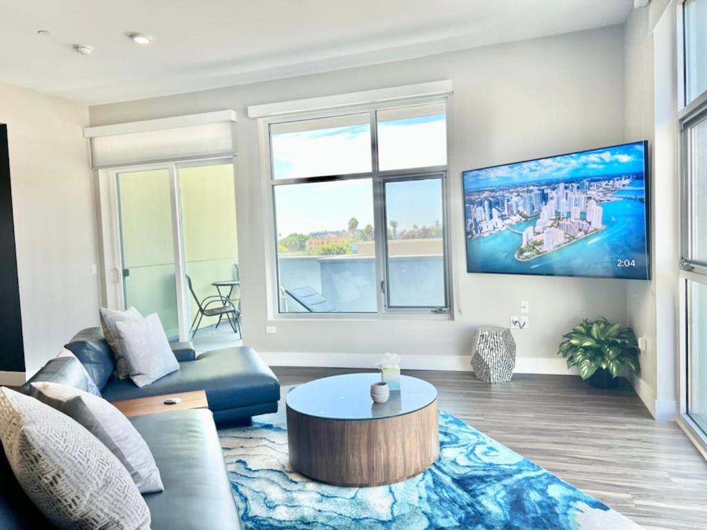 a living room with a couch and a table at Large Hollywood Corner 2 Bedroom with Private Balcony in Los Angeles