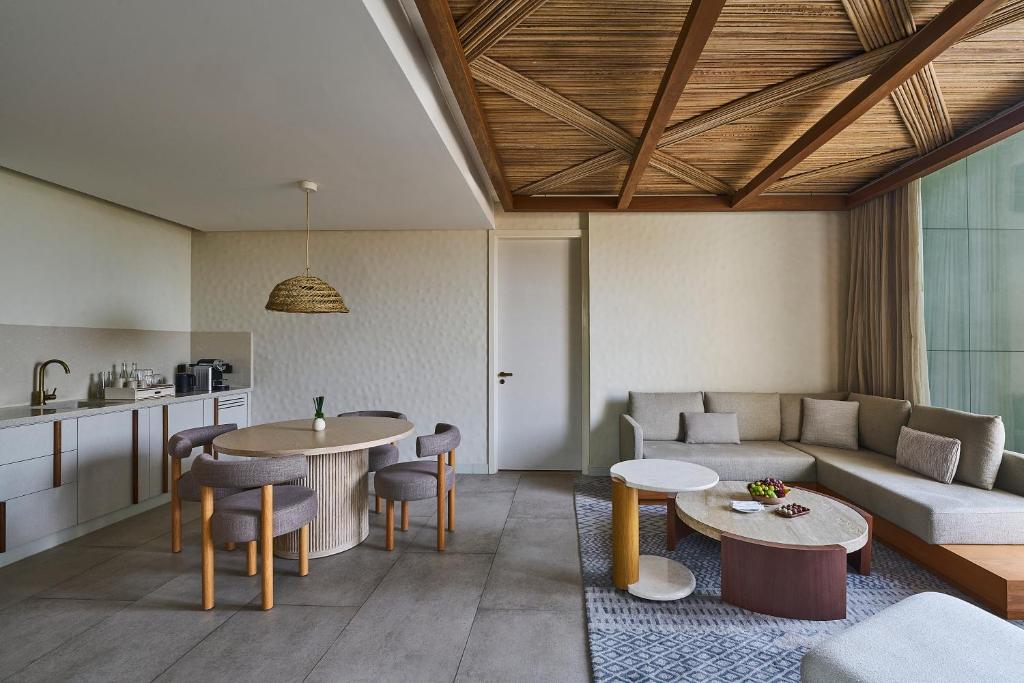 a living room with a couch and a table at ERTH Abu Dhabi Hotel in Abu Dhabi