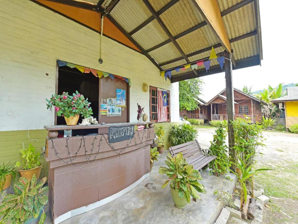 a restaurant with a bench in front of a building at Pelangi Beach Resort in Cherating