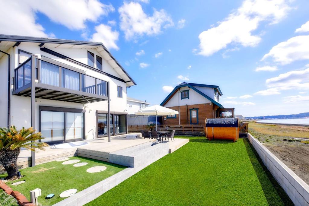 a house with a large backyard with green grass at Ocean Resort Tateyama T House - Vacation STAY 69839v in Tateyama