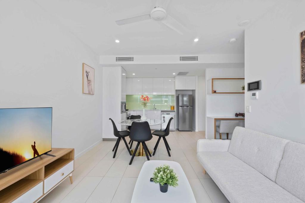 a living room with a white couch and a table at Modern 1BR in the Heart of South Brisbane w Wifi Parking in Brisbane