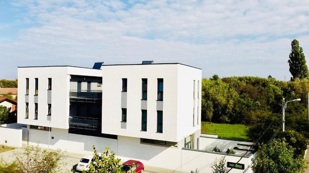 a white building with black windows at Casa Maria City Apartments in Timişoara