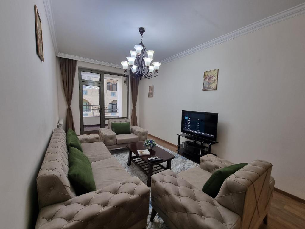 Sala de estar con 2 sofás y TV en Fontain apartment, en Baku