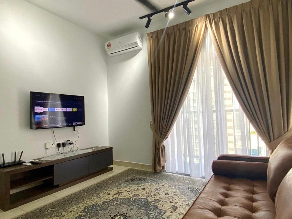 a living room with a couch and a large window at Tifa Home, Alanis Residence Kota Warisan KLIA Sepang Netflix in Sepang