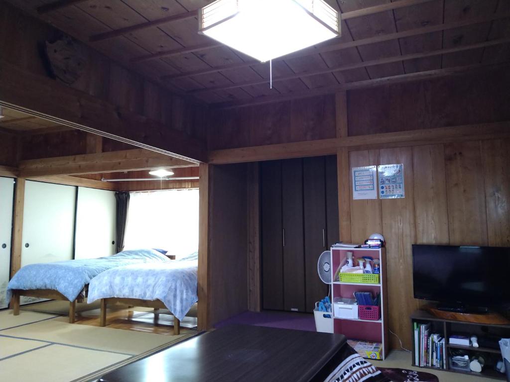 Postel nebo postele na pokoji v ubytování Cottage Yakusugi House