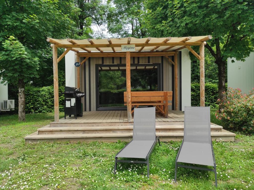 a gazebo with two chairs and a bench at Family&#39;s Camping Le Savoy in Challes-les-Eaux