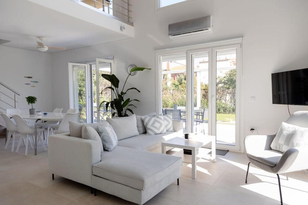 a white living room with a white couch and chairs at A Homes Greece Athens - Luxurious Beach Villa with Private Garden in Nea Makri