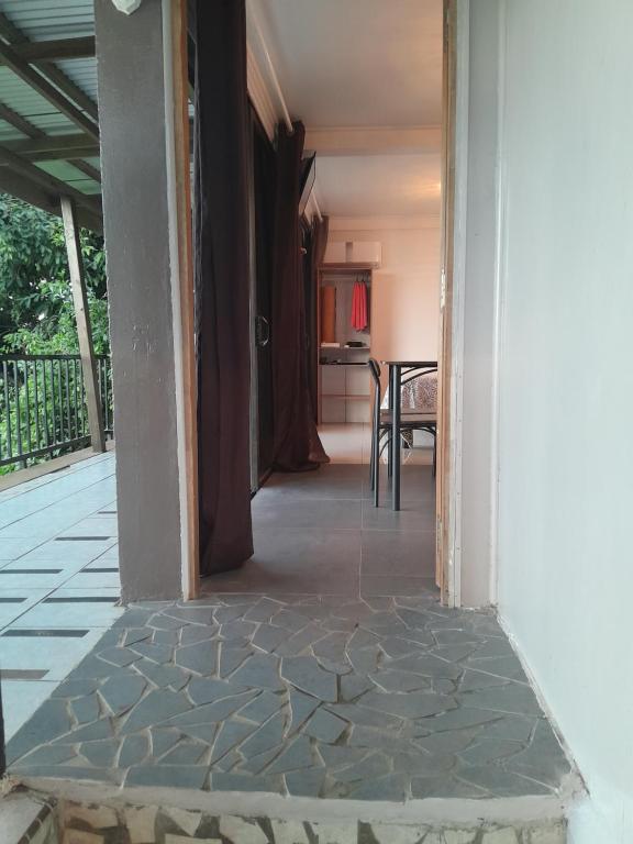 a hallway of a house with a kitchen and a table at CHEZ KIKI & MIMI 