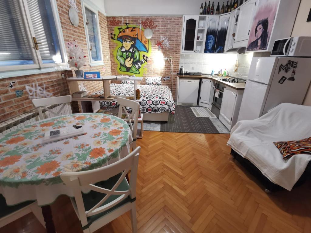 a kitchen with a table and chairs and a kitchen with a dining room at Street Art Suite in Zagreb