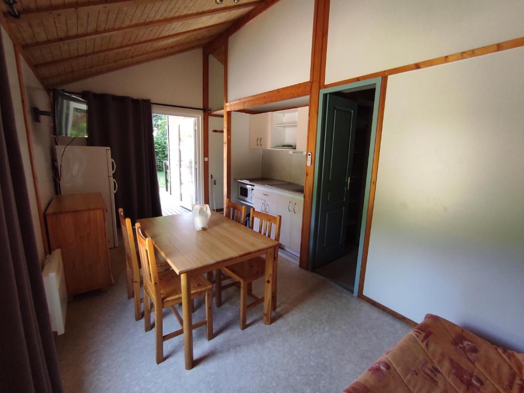a kitchen and dining room with a table and chairs at Family&#39;s Camping Le Savoy in Challes-les-Eaux