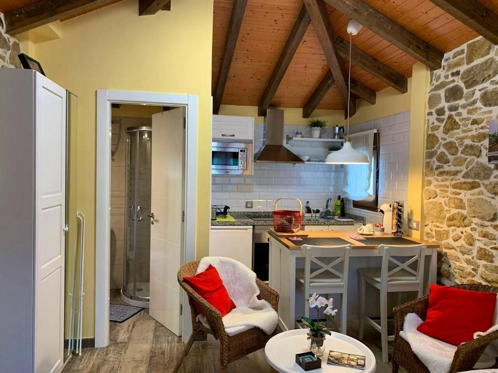 a kitchen with a table and chairs in a room at One bedroom house with shared pool terrace and wifi at Biescas in Biescas