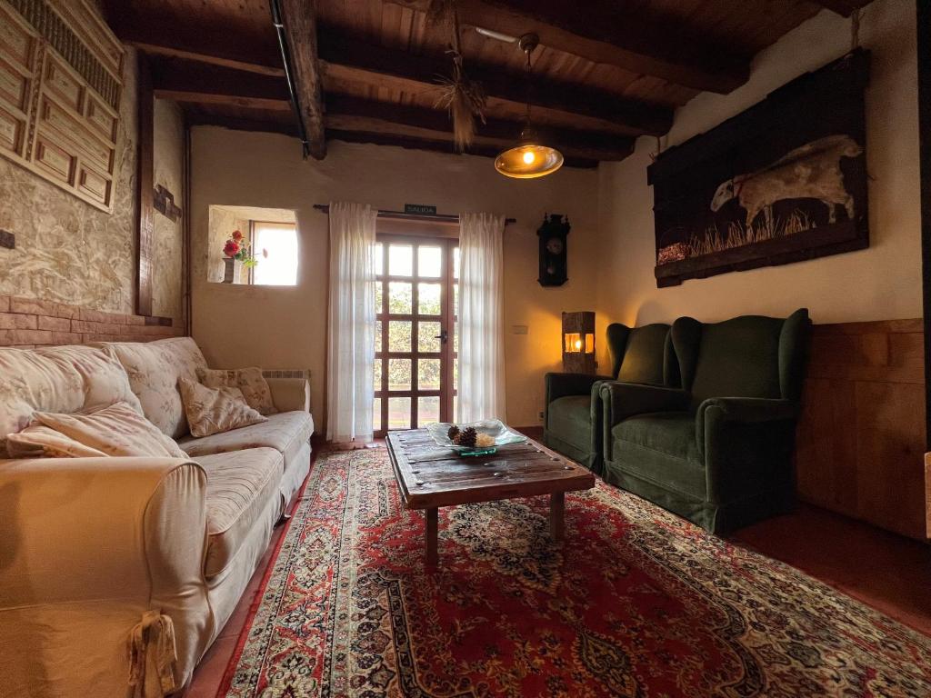 ein Wohnzimmer mit einem Sofa und einem Tisch in der Unterkunft La casa del río in Alameda del Valle