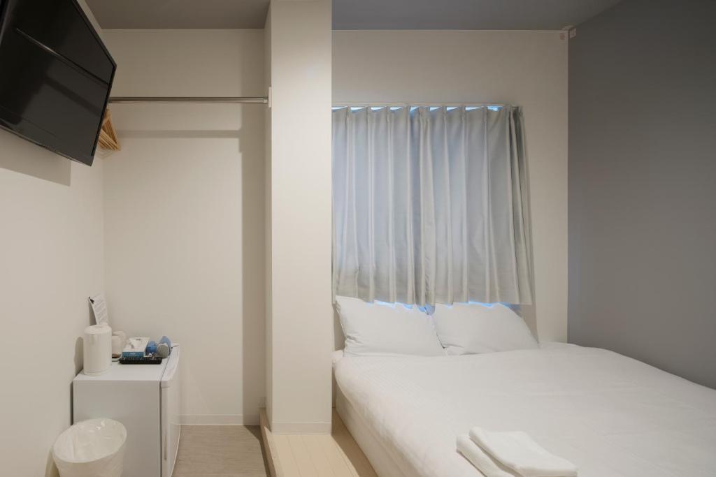 Postel nebo postele na pokoji v ubytování Iwatoyama Hostel