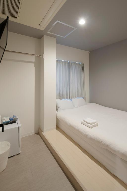 Postel nebo postele na pokoji v ubytování Iwatoyama Hostel
