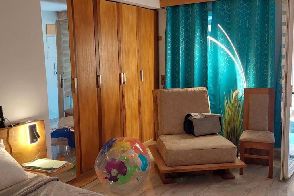 a living room with a chair and a globe in a room at Suite ultra moderne Wi-Fi in Yaoundé