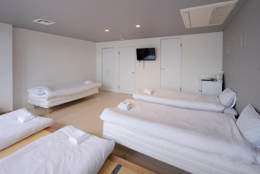 Postel nebo postele na pokoji v ubytování Iwatoyama Hostel