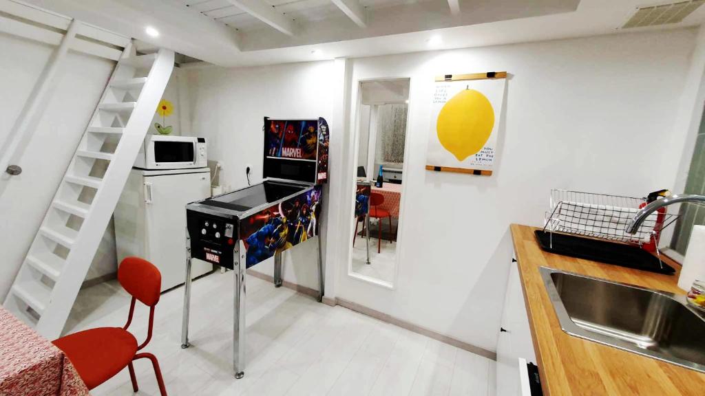 a small kitchen with a sink and a counter top at Pinball Apartment in Budapest