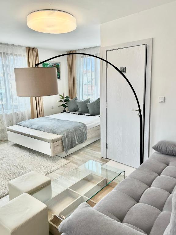 a bedroom with a bed and a glass table at Bulgarane House in Govedartsi