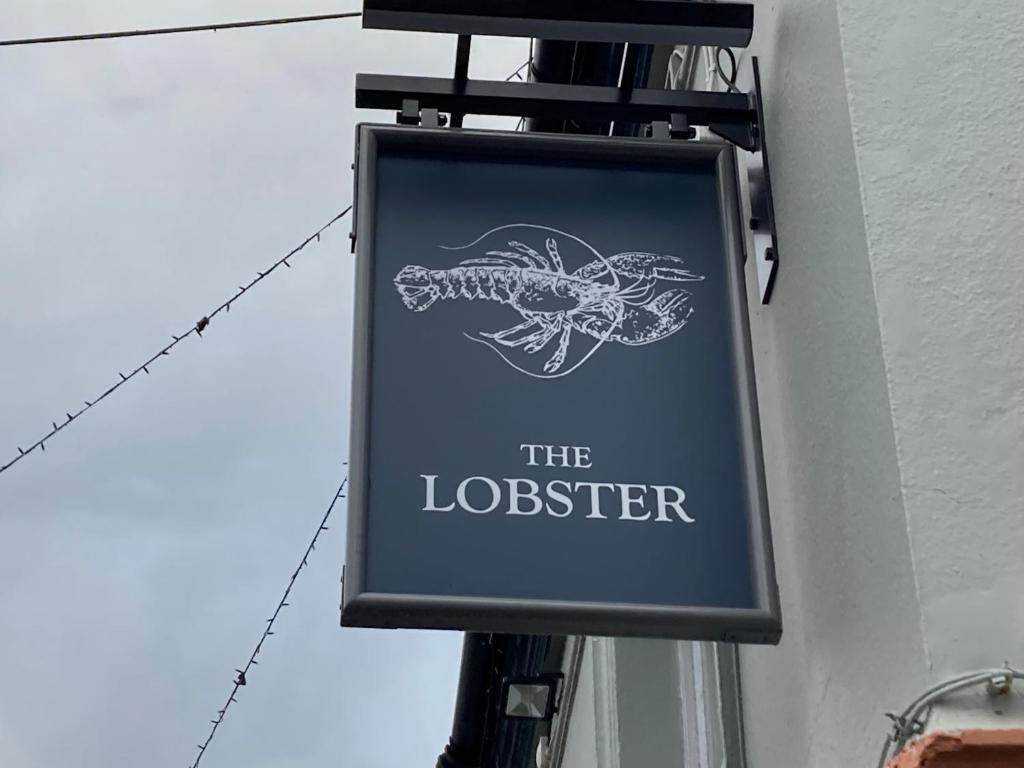 a sign for the lobster on the side of a building at The Lobster in Sheringham