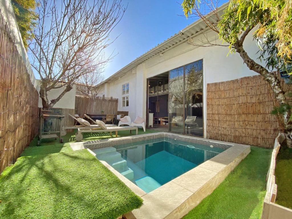 a swimming pool in the backyard of a house at Casa Lavander in Barcelona