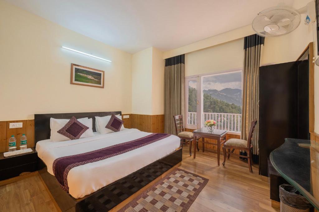 a hotel room with a bed and a window at Seven Hills Shimla by Him Haults Hospitality in Shimla