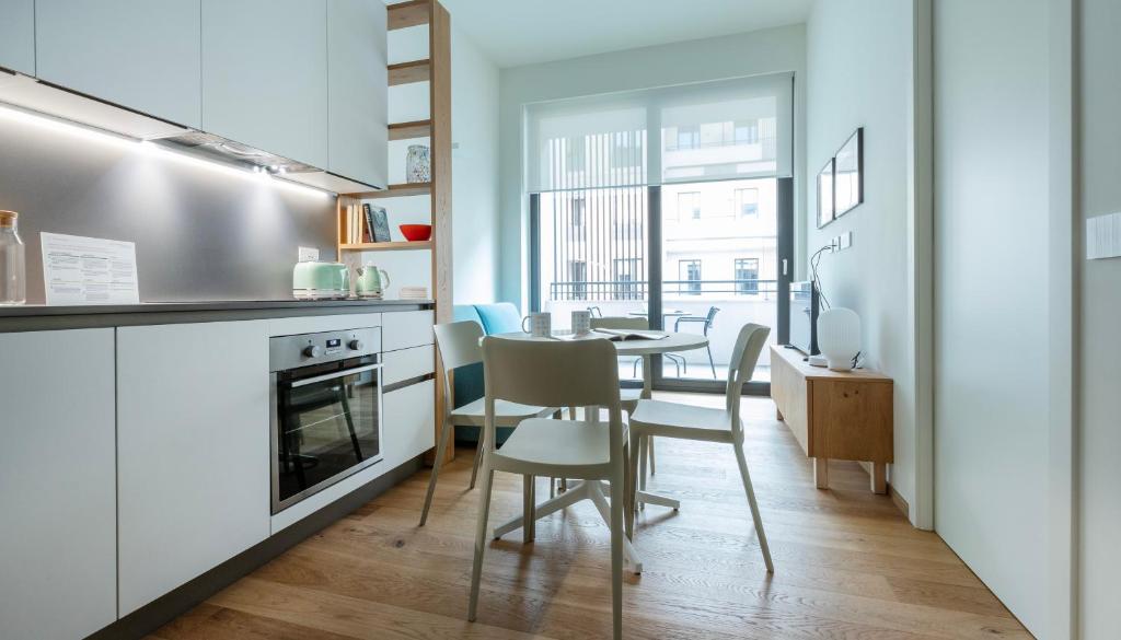 a kitchen and dining room with a table and chairs at Italianway - Cecchi 18 B in Milan