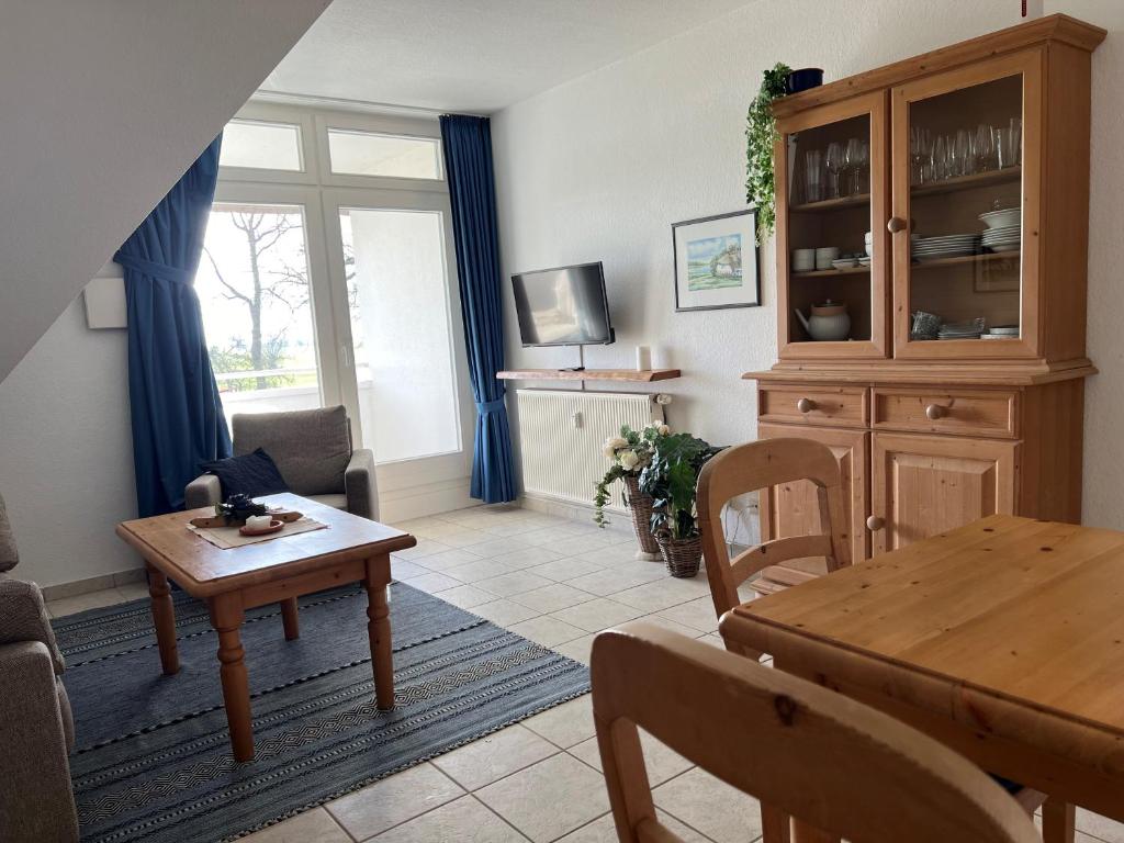 a living room with a table and a dining room at Das Landhaus am Haff B10 in Stolpe