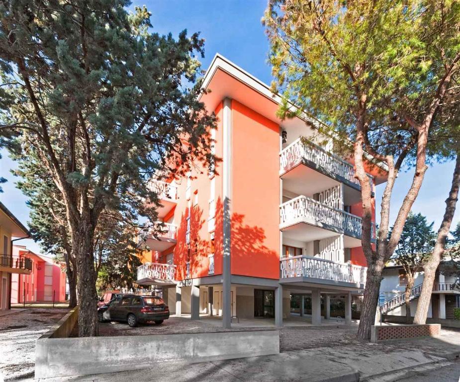 an orange building with trees in front of it at Apartment in Bibione 24409 in Bibione