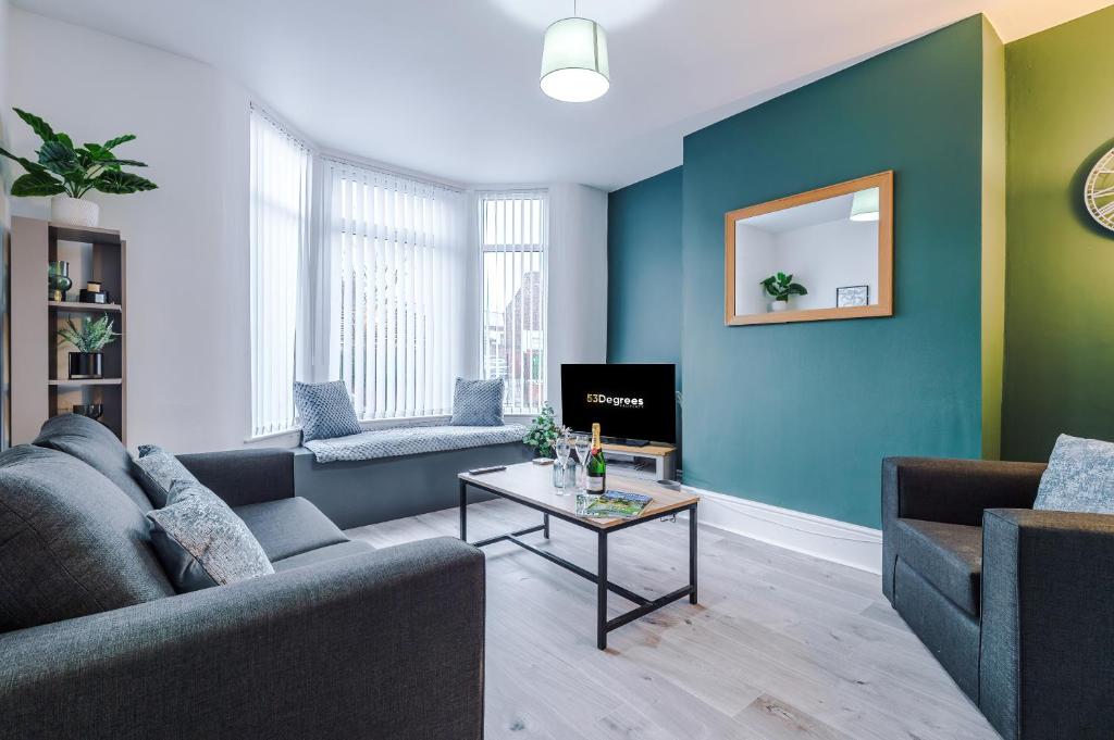 a living room with a couch and a table at Stunning 3-bed home in Anfield by 53 Degrees Property, Ideal For Big Groups, FREE parking! in Liverpool