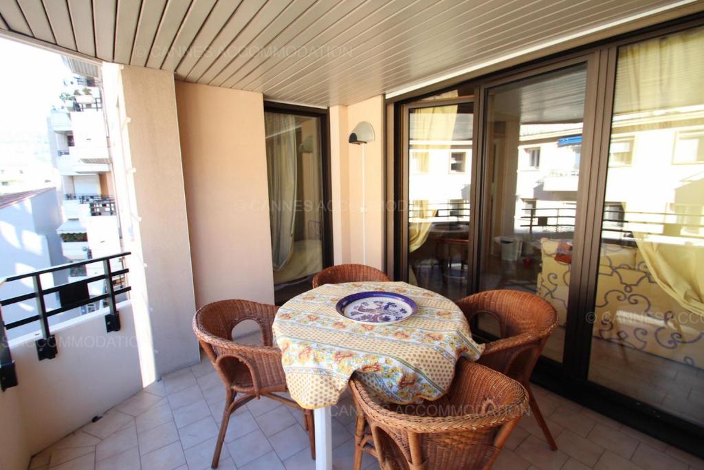 une table et des chaises assises sur un balcon dans l'établissement Alessandra, à Cannes