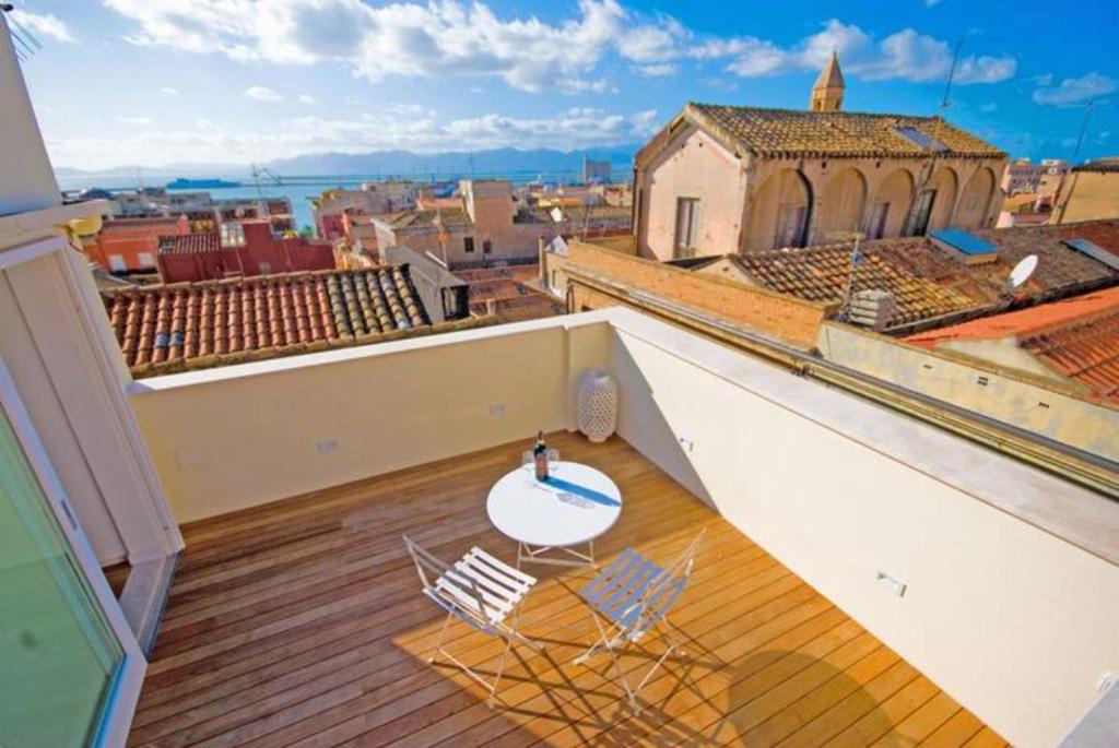 a balcony with two chairs and a table on a building at Blue Domus in Cagliari